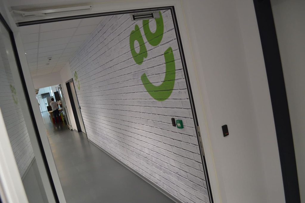 Ao.com - branding project - digitally printed brick wall with logo wallpaper graphics.