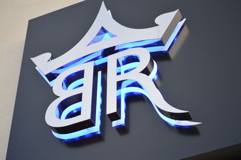 Barton Rouge - 3D built up polished stainless steel letters with blue LED halo illumination.